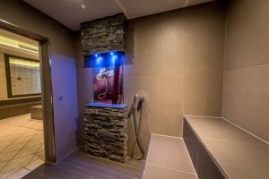 a bathroom with a stone wall and a shower with blue lights at Schloß-Hotel Petry in Treis-Karden +64 photos