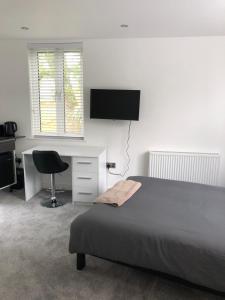 A television and/or entertainment centre at Self contained ensuite double bedroom with own entrance FREE OFF STREET PARKING