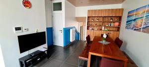 a living room with a table and a television at SUN and FUN in Blankenberge