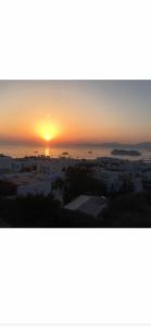 
a sunset view of a beach with a sunset at Ibiscus Boutique in Mikonos
