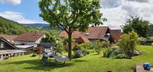 a swing in the yard of a house at Ferienwohnung Annemarie in Gernsbach