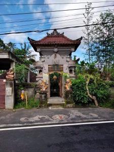 a building with a gate in the middle of a street at Legawa Guest House in Tegalalang +3 photos