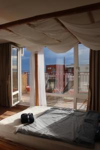 a bedroom with a bed with a view of a balcony at Fort Noxs, Sea Together in Elenite