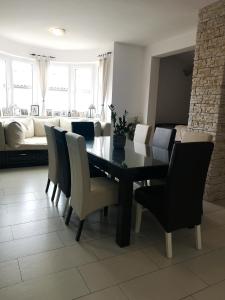 a dining room with a table and chairs and a couch at Apartma Isabella in Sečovlje