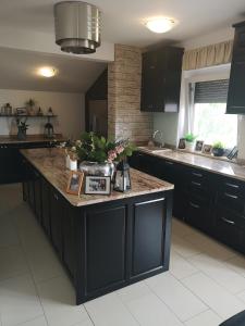 a kitchen with a large island in the middle at Apartma Isabella in Sečovlje