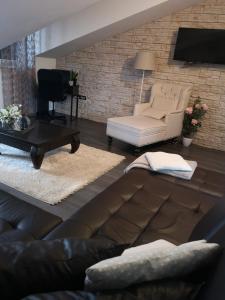 a living room with a couch and a chair at Apartma Isabella in Sečovlje +10 photos