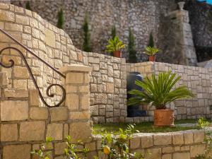 
a stone wall with a stone wall and a stone wall with a brick wall at Shangri La Mansion in Mostar
