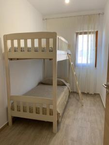 a bedroom with two bunk beds and a window at The quiet place in Hamallë