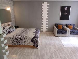 a bedroom with a zebra print bed and a couch at Apartment VIP in Tiraspol