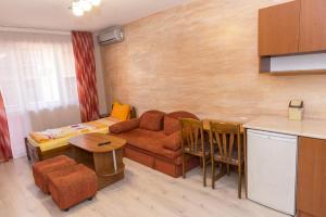 a living room with a couch and a table at Къща за гости Мони in Sandanski