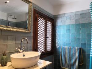 a bathroom with a sink and a mirror at Casa Cervantes in Alhama de Granada
