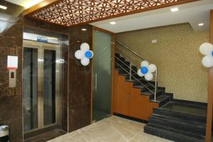 a hallway with blue and white balloons in a building at century courtyard in Chennai