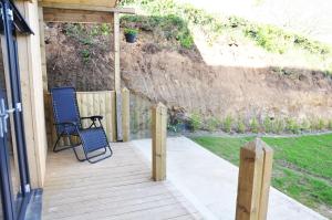 a porch with two chairs and a fence at FOYLE VIEW CABIN in Greencastle