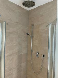 a shower with a glass door in a bathroom at Luxury Duplex in Luxembourg Center Free Parking 5 min walk to the tram in Luxembourg