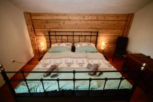 a bedroom with a large bed with a wooden wall at Basislager Fieberbrunn in Fieberbrunn