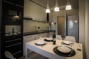 a kitchen with a table with wine glasses on it at APARTMAN SIMIC - STAN NA DAN in Bogatić