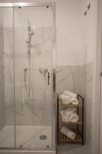 a shower with a glass door and towels in a bathroom at Casanica-Taormina in Taormina