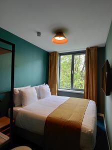 En eller flere senge i et værelse på FD Hotels