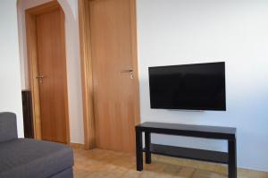 a living room with a flat screen tv on a wall at Casa Vitorino in Sagres
