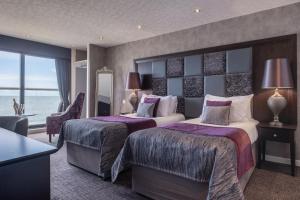 a hotel room with two beds and a view of the ocean at Number 44 Hotel & Bar in Stonehaven +29 photos