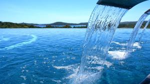 a water hose coming out of a boat in the water at U Paesolu in Sainte-Lucie de Porto-Vecchio