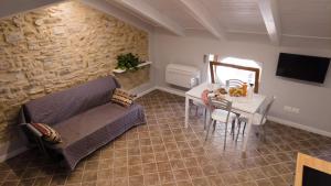 a living room with a couch and a table and a mirror at Da Palù in Castellabate