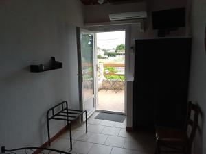 a room with a door leading to a patio at Le H de SERNHAC in Sernhac