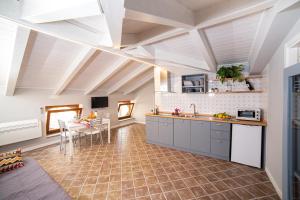 a large kitchen with a dining room and a table at Da Palù in Castellabate