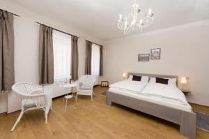 a bedroom with a bed and a table and chairs at Pension Faber in Český Krumlov