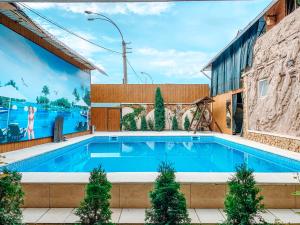 a swimming pool in front of a building at Villa de Nord in Soroca