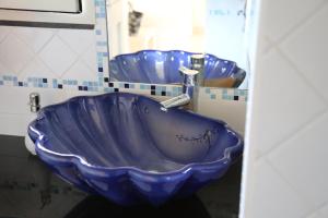a blue bowl sink in a bathroom with two sinks at Hotel Scilla in Scilla +37 photos
