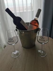 a bucket with a bottle of wine and two glasses at Hotel Riviera in Mamaia