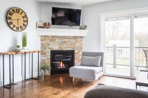 a living room with a chair and a fireplace at “Hygge” 3BDR townhouse, Close to beach, park & wineries! in Traverse City