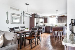 a kitchen and dining room with a table and chairs at “Hygge” 3BDR townhouse, Close to beach, park & wineries! in Traverse City