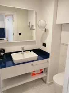 a bathroom with a sink and a mirror at Subtropik Apartments in Batumi in Batumi