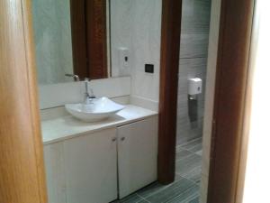a bathroom with a white sink and a mirror at Hotel Vila Lule in Durrës