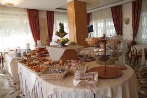 a table with a buffet of food on it at Hotel Adriatica sul Mare in Rimini