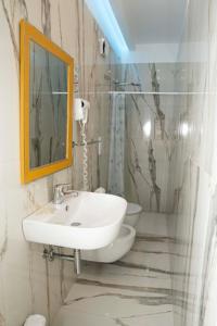 a bathroom with a sink and a mirror at Al Ristoro in Torre Santa Sabina