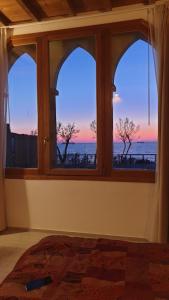 a room with a window with a view of the ocean at Cala Dei Mori in Livorno