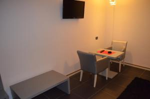 TV a/nebo společenská místnost v ubytování Hotel Mustang