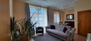 a living room with a couch and a large window at CasAzulApartments in Sintra