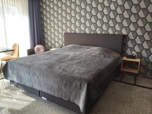 Een bed of bedden in een kamer bij Hotel Maurice