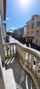a balcony with a white railing on a city street at CasAzulApartments in Sintra