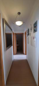 an empty hallway with a window and a ceiling at CasAzulApartments in Sintra