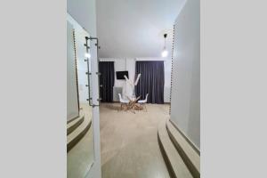 a view of a room with a table and a mirror at Apartment in the heart of the city 4 in Larisa