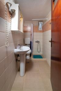a bathroom with a sink and a toilet and a shower at La Stella Apartments in Amoudara Herakliou