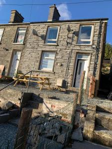 a brick house with a fence in front of it at The Anchorage Snowdonia in Blaenau-Ffestiniog +9 photos