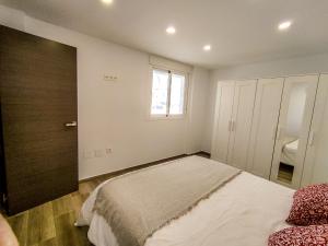 Posteľ alebo postele v izbe v ubytovaní Apartamentos La Libertad 1
