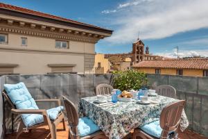 a table and chairs on a balcony with a view at Design Apartments Florence- Florence City Center in Florence