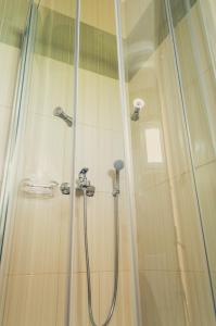 a bathroom with a shower with a glass door at Kiani Akti in Katelios